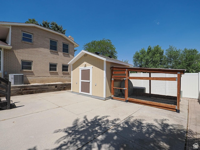 2333 W Ledgewood Dr, Taylorsville, UT 84129 - rear view of property featuring a patio area and a storage shed