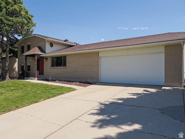 2333 W Ledgewood Dr, Taylorsville, UT 84129 - view of front of house with driveway, brick siding, a front yard, and an attached garage