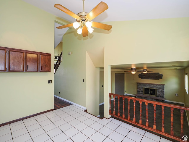 2333 W Ledgewood Dr, Taylorsville, UT 84129 - kitchen with ceiling fan, a fireplace, high vaulted ceiling, and light tile patterned floors