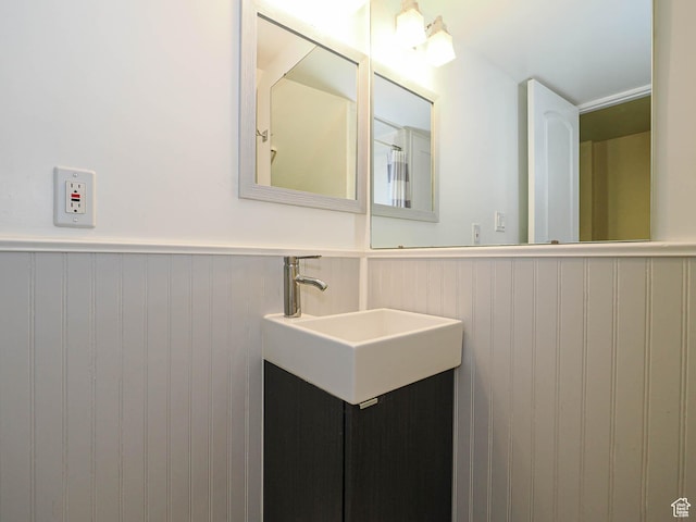 2333 W Ledgewood Dr, Taylorsville, UT 84129 - bathroom featuring a wainscoted wall and vanity