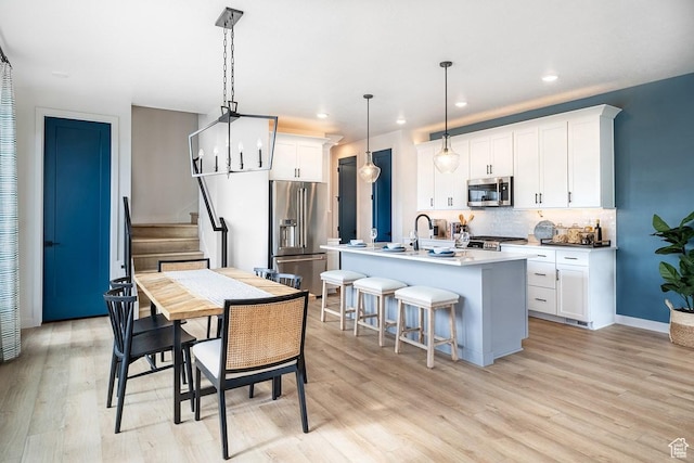 5063 W Rambutan Way S Unit 121, South Jordan, UT 84009 - dining room featuring light wood-type flooring, recessed lighting, and stairs