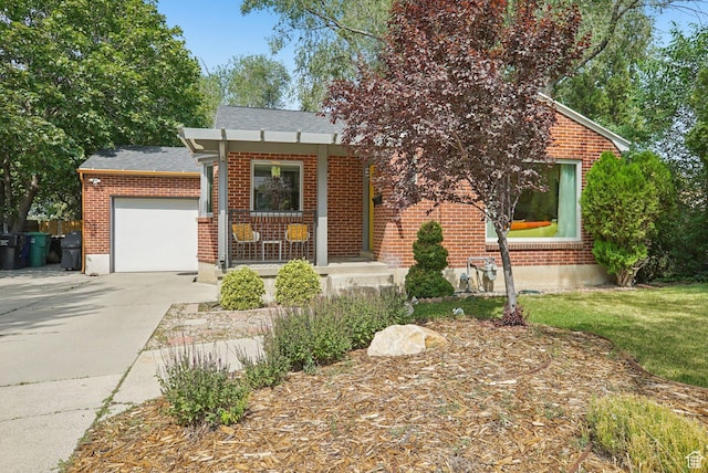 3232 S 2600 E, Salt Lake City, UT 84109 - view of front of home with brick siding, driveway, a garage, a porch, and a shingled roof