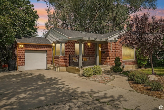 3232 S 2600 E, Salt Lake City, UT 84109 - ranch-style house with covered porch, driveway, an attached garage, and brick siding
