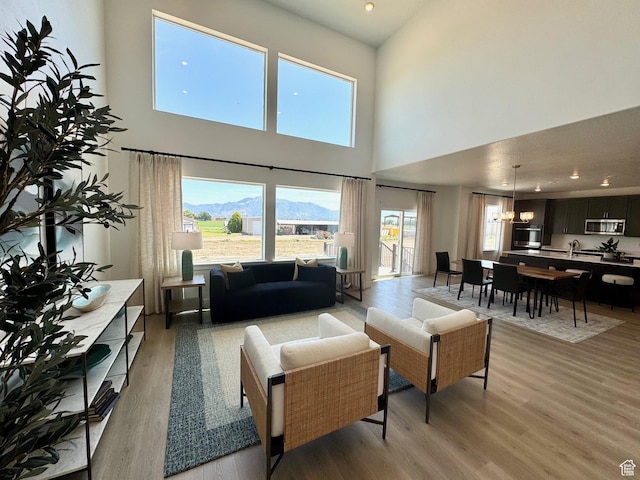 4230 W 1575th St S Unit 305, Ogden, UT 84401 - living area featuring a high ceiling, light wood-style flooring, plenty of natural light, a chandelier, and recessed lighting