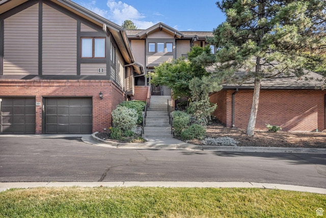 7430 S Wasatch Blvd E Unit I-2, Cottonwood Heights, UT 84121 - view of property featuring brick siding, asphalt driveway, a garage, and stairway