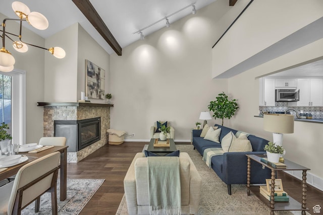 7430 S Wasatch Blvd E Unit I-2, Cottonwood Heights, UT 84121 - living room with a glass covered fireplace, track lighting, dark wood-style floors, a towering ceiling, and beam ceiling