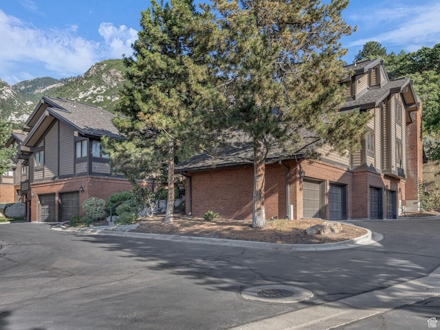 7430 S Wasatch Blvd E Unit I-2, Cottonwood Heights, UT 84121 - view of front of house with an attached garage, brick siding, and driveway