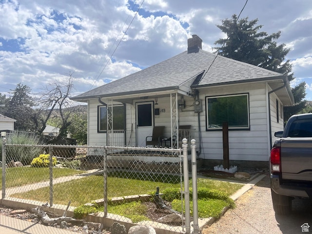 148 Duchesne St, Helper, UT 84526 - bungalow-style home with roof with shingles, covered porch, and a chimney