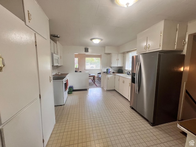148 Duchesne St, Helper, UT 84526 - kitchen featuring white appliances, white cabinets, and light countertops