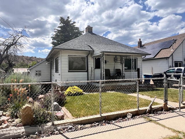 148 Duchesne St, Helper, UT 84526 - view of front of house featuring a fenced front yard, a porch, a chimney, roof with shingles, and a gate