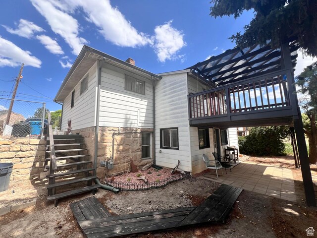 148 Duchesne St, Helper, UT 84526 - rear view of property with a patio area, a chimney, and stairway