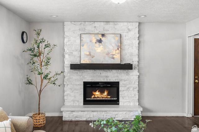 1456 Swan St, Ogden, UT 84401 - living room featuring wood finished floors, a stone fireplace, and a textured ceiling