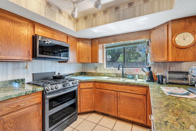 3286 Danish Hills Cir, Cottonwood Heights, UT 84121 - kitchen with stainless steel appliances, brown cabinets, light tile patterned flooring, light stone countertops, and rail lighting