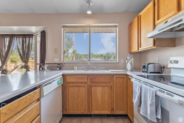 8770 S 3980 W, West Jordan, UT 84084 - kitchen featuring white appliances, under cabinet range hood, light tile patterned floors, light countertops, and brown cabinetry