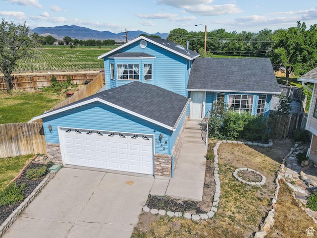 8770 S 3980 W, West Jordan, UT 84084 - traditional-style home with a mountain view, driveway, roof with shingles, brick siding, and a garage