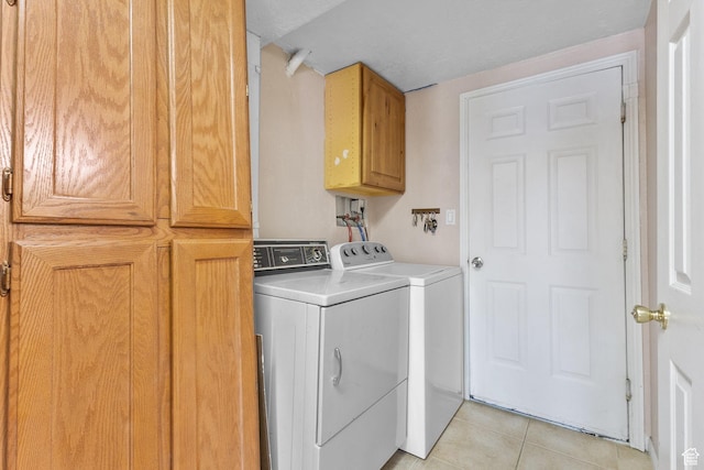 8770 S 3980 W, West Jordan, UT 84084 - laundry area featuring cabinet space, washing machine and clothes dryer, and light tile patterned floors
