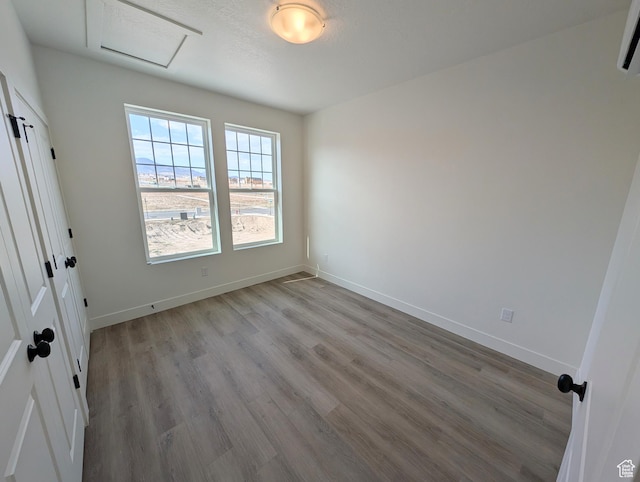 11369 S Watercourse Rd W Unit 202, South Jordan, UT 84009 - unfurnished room with attic access, light wood-type flooring, and a wall unit AC