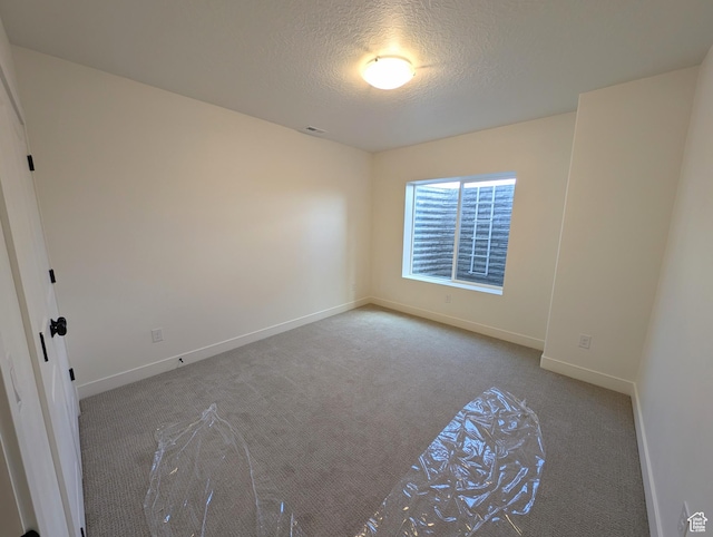 11369 S Watercourse Rd W Unit 202, South Jordan, UT 84009 - carpeted spare room featuring a textured ceiling and baseboards