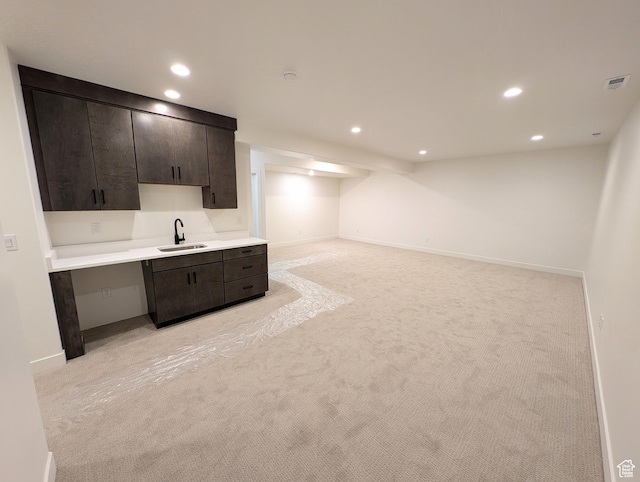 11369 S Watercourse Rd W Unit 202, South Jordan, UT 84009 - kitchen featuring light colored carpet, recessed lighting, light countertops, and dark brown cabinets