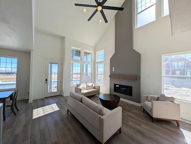 11369 S Watercourse Rd W Unit 202, South Jordan, UT 84009 - living room with high vaulted ceiling, ceiling fan, a glass covered fireplace, wood finished floors, and recessed lighting