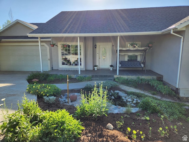 2313 N 850 E, Lehi, UT 84043 - view of front of house with stucco siding, covered porch, a garage, and a shingled roof