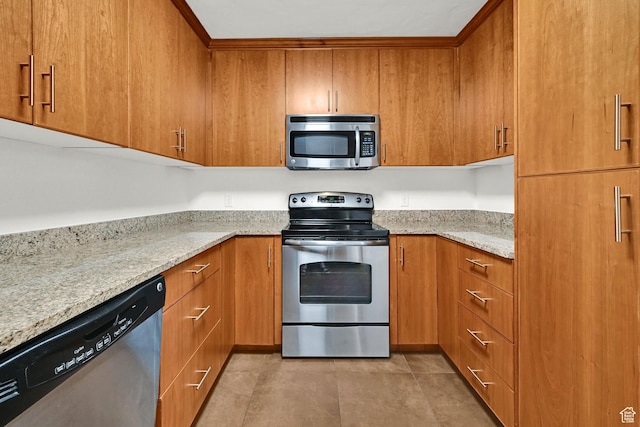230 E Broadway S Unit 1108, Salt Lake City, UT 84111 - kitchen featuring stainless steel appliances, brown cabinetry, and light stone countertops