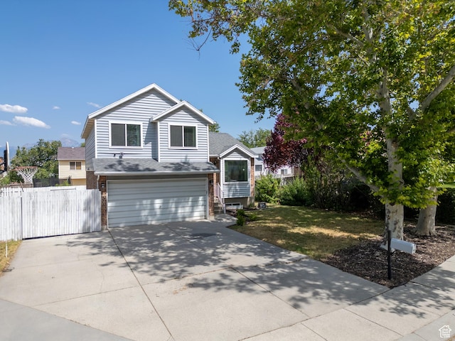 8823 S 3715 W, West Jordan, UT 84088 - view of front of home with a garage, driveway, brick siding, and roof with shingles