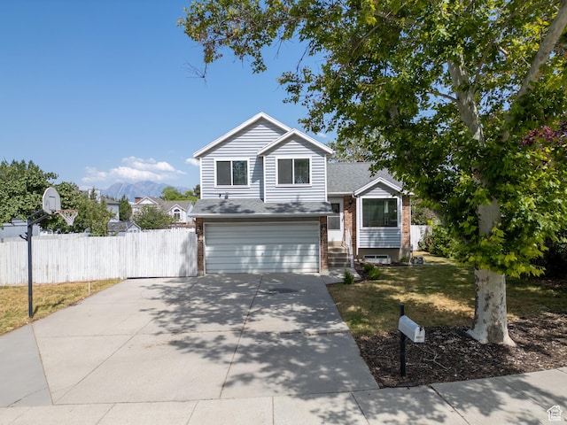 8823 S 3715 W, West Jordan, UT 84088 - split level home with brick siding, an attached garage, concrete driveway, and roof with shingles