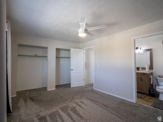 8823 S 3715 W, West Jordan, UT 84088 - unfurnished bedroom featuring multiple closets, carpet, connected bathroom, ceiling fan, and a textured ceiling