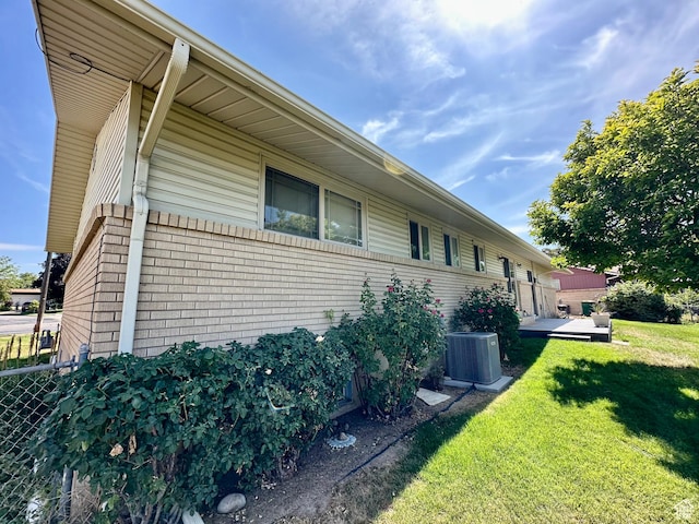 1208 Valhalla Dr, Clearfield, UT 84015 - view of side of home featuring a central AC unit and brick siding