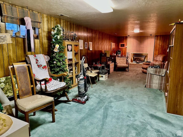 1208 Valhalla Dr, Clearfield, UT 84015 - sitting room with a fireplace, carpet floors, wooden walls, and a textured ceiling