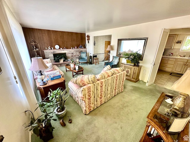 1208 Valhalla Dr, Clearfield, UT 84015 - living area with light colored carpet, wood walls, and a fireplace