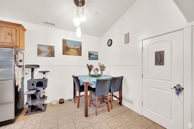 1045 S 1700 W Unit 133, Payson, UT 84651 - dining room featuring a wainscoted wall, vaulted ceiling, a decorative wall, and light tile patterned flooring