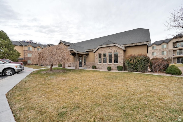 1045 S 1700 W Unit 133, Payson, UT 84651 - view of front of house featuring a front yard, brick siding, and a shingled roof
