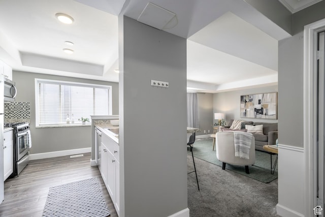 2220 E Murray Holladay Rd S Unit 75, Salt Lake City, UT 84117 - kitchen with appliances with stainless steel finishes, a raised ceiling, white cabinets, and light countertops