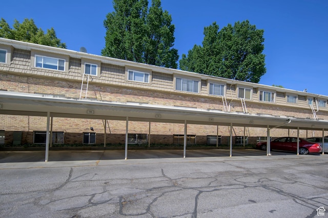 2220 E Murray Holladay Rd S Unit 75, Salt Lake City, UT 84117 - view of front of property with brick siding and covered parking