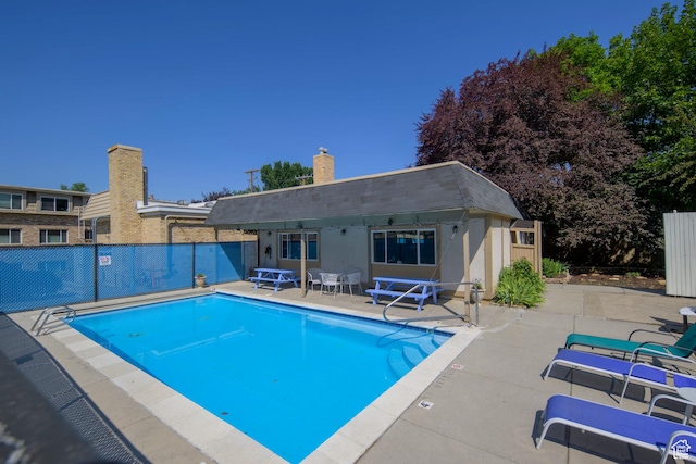 2220 E Murray Holladay Rd S Unit 75, Salt Lake City, UT 84117 - community pool with a patio area, a storage structure, and an outbuilding