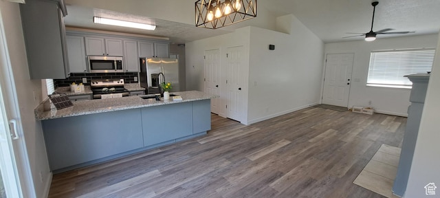 1496 N Monroe, Ogden, UT 84404 - kitchen with stainless steel appliances, ceiling fan, tasteful backsplash, a peninsula, and gray cabinetry