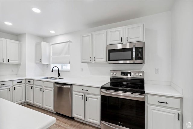 321 E 1040 N, Orem, UT 84057 - kitchen with appliances with stainless steel finishes, light wood-style floors, white cabinetry, light countertops, and recessed lighting