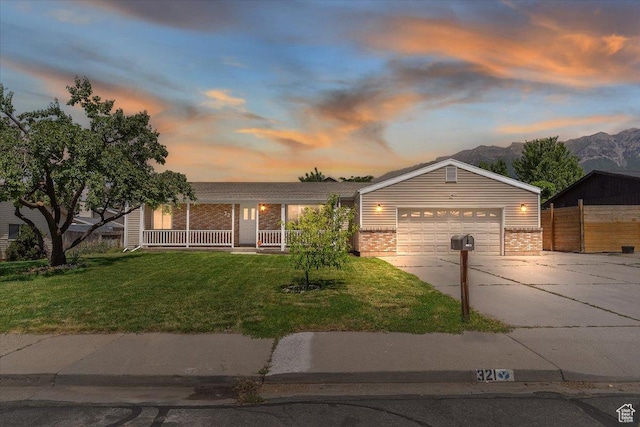 321 E 1040 N, Orem, UT 84057 - ranch-style house featuring brick siding, concrete driveway, covered porch, and a mountain view
