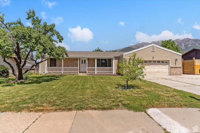 321 E 1040 N, Orem, UT 84057 - ranch-style house with brick siding, concrete driveway, a garage, a porch, and a front lawn