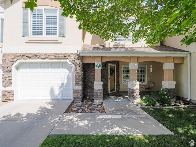 11965 S Draperville Ave, Draper, UT 84020 - view of front of property featuring stucco siding, stone siding, an attached garage, and a porch
