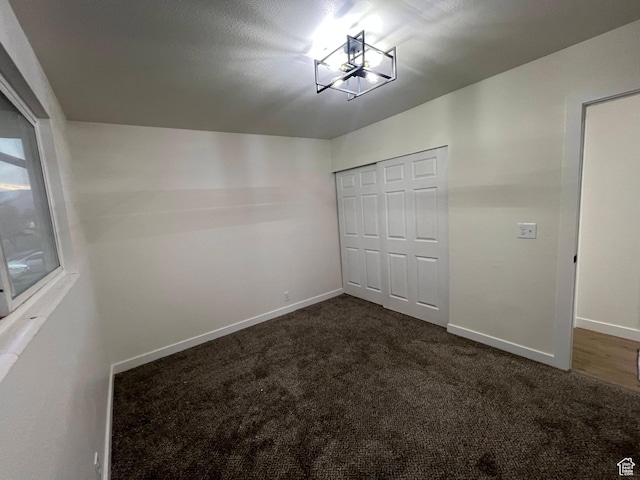 6770 W 3860 S, West Valley City, UT 84128 - unfurnished bedroom featuring dark carpet and a closet