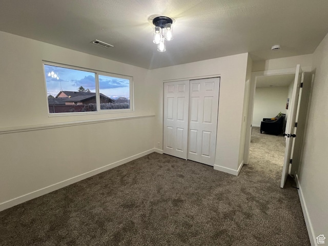 6770 W 3860 S, West Valley City, UT 84128 - unfurnished bedroom featuring dark colored carpet and a closet