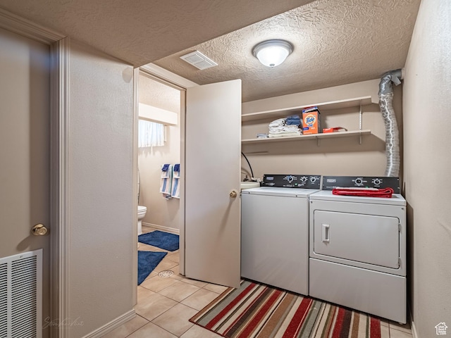 320 S 2nd St W, Soda Springs, ID 83276 - laundry area featuring separate washer and dryer, light tile patterned floors, and a textured ceiling
