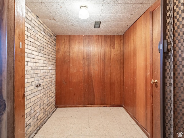 320 S 2nd St W, Soda Springs, ID 83276 - hall featuring light floors, wood walls, and brick wall