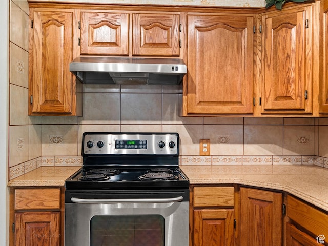 320 S 2nd St W, Soda Springs, ID 83276 - kitchen featuring electric range, under cabinet range hood, tasteful backsplash, and brown cabinetry