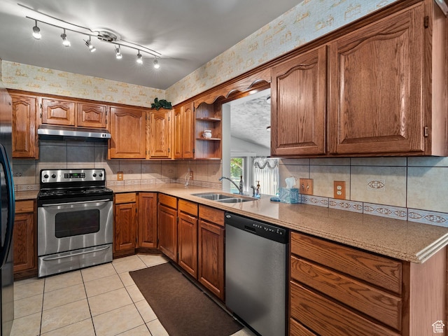 320 S 2nd St W, Soda Springs, ID 83276 - kitchen featuring stainless steel appliances, wallpapered walls, under cabinet range hood, brown cabinets, and light tile patterned floors