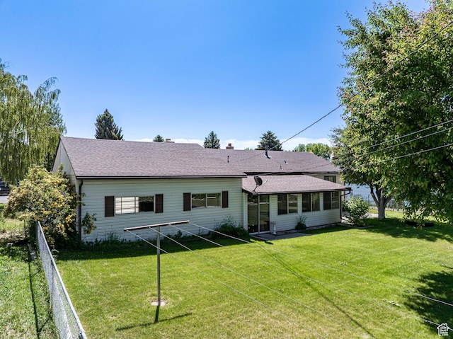 320 S 2nd St W, Soda Springs, ID 83276 - back of house with a lawn and roof with shingles