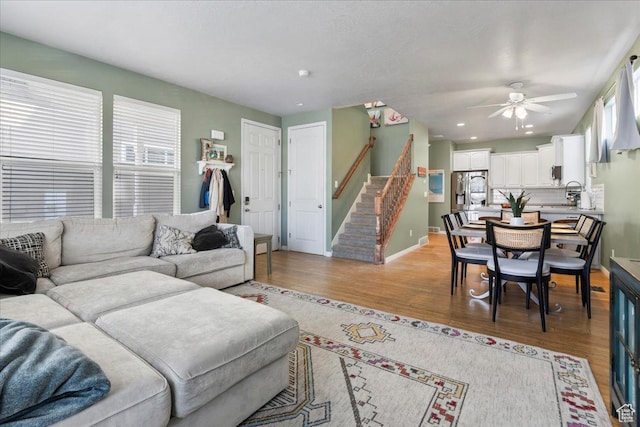 5023 W Currant Dr S, South Jordan, UT 84009 - living room with stairs, light wood-style floors, a ceiling fan, and recessed lighting